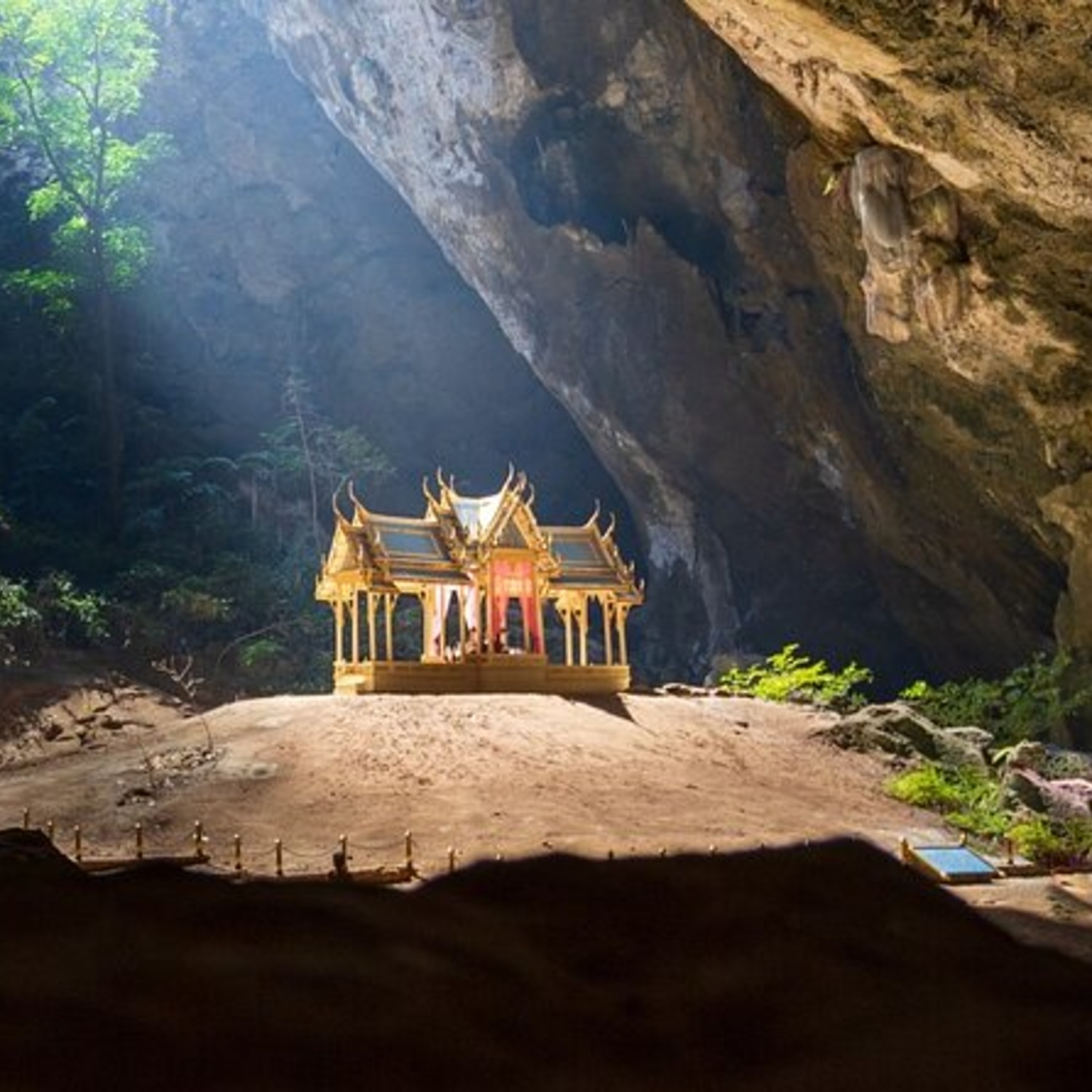 Sunlit golden royal pavilion inside Phraya Nakhon Cave near Lyndale Lodge
